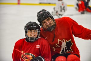 Young Thrashers skate with Team Canada sledge hockey players