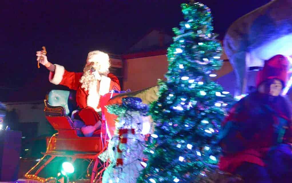 
                     Santa Claus rode into Wellesley Friday evening for the annual Christmas Tyme parade, which features floats that light up the 
                     